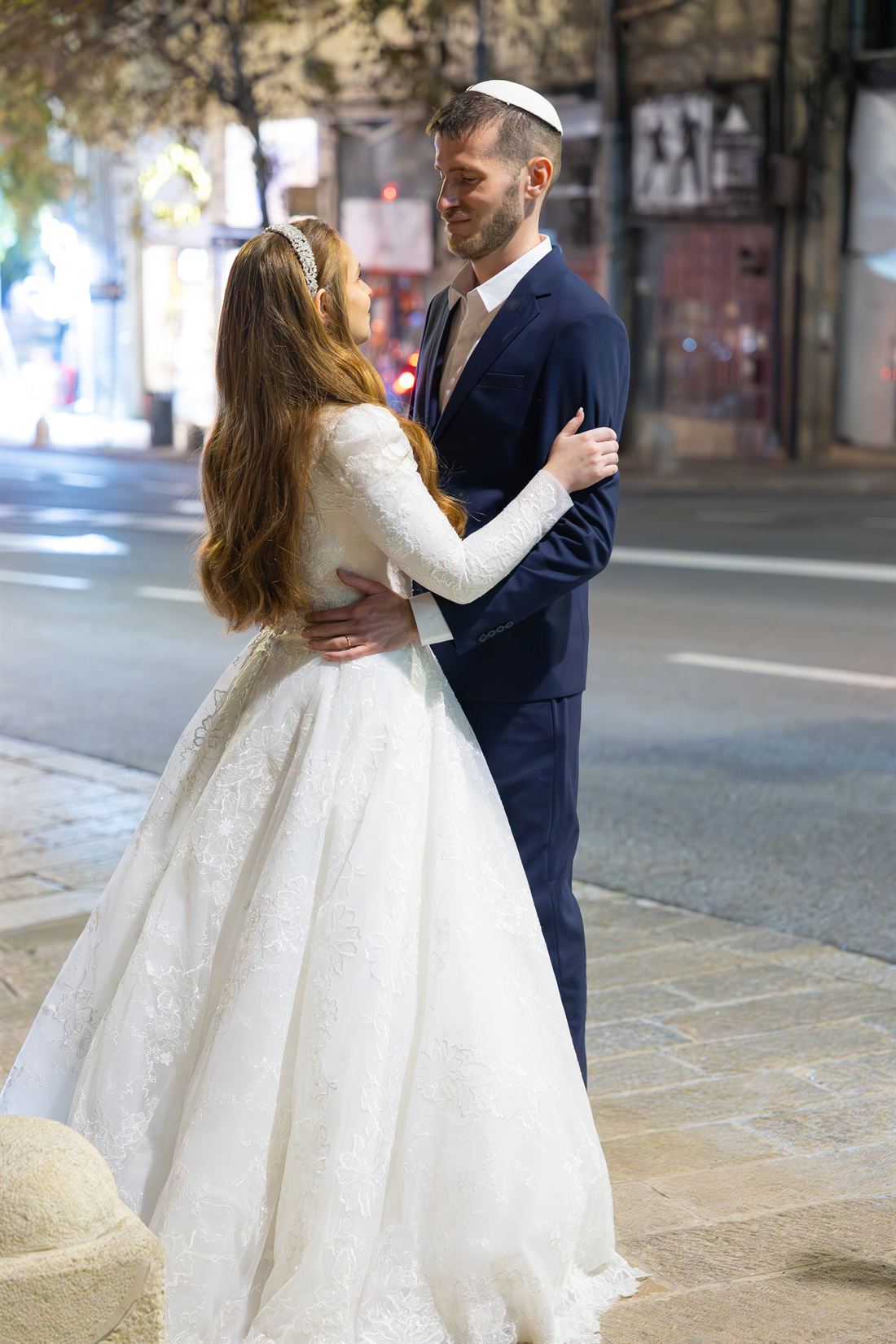 Wedding couple sharing a quiet portrait in the city.